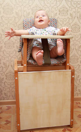 adorable baby on highchair, at homeの写真素材