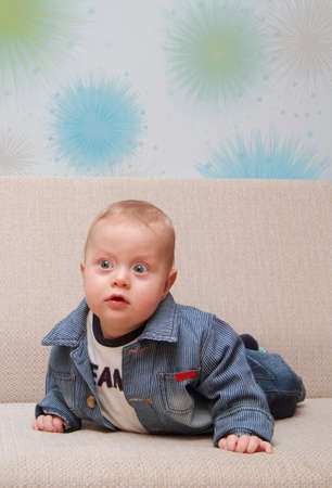 baby try to creep on couchの写真素材