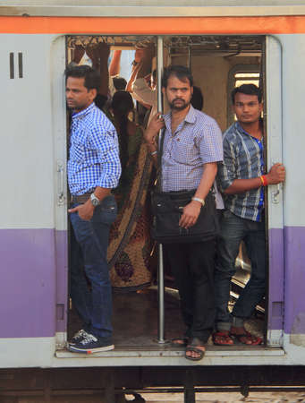 Mumbai, India - February 27, 2015 people are standing in the moving carriage of local train, Mumbai, Indiaのeditorial素材