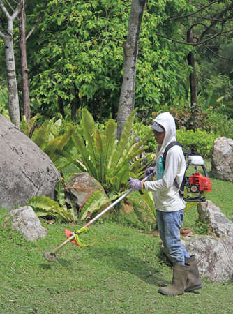 Kuala Lumpur, Malaysia - April 2, 2015: lawn mower man is doing his work in botanical garden of Kuala Lumpur, Malaysiaのeditorial素材