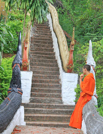 Luang Prabang, Laos - May 22, 2015 buddhist monk is thinking about something nearly the templeのeditorial素材