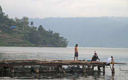 Parapat, Indonesia - April 13, 2015: people are standing on the pier  in Parapat,the north Sumatra, Indonesiaのeditorial素材