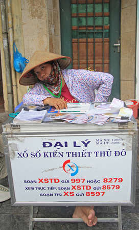 Hanoi, Vietnam - June 1, 2015: woman sells lottery tickets on streetin Hanoiのeditorial素材