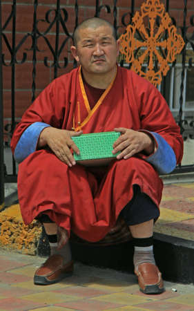 Ulaanbaatar, Mongolia - July 8, 2015: monk is sitting nearly buddhist temple
