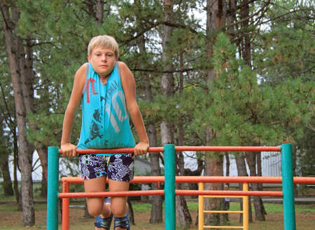boy on the top of ladder on play area