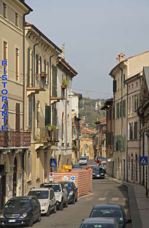 narrow street with many cars in Verona, Italyの写真素材