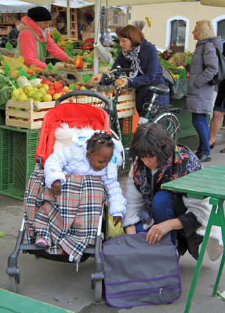 Ljubljana, Slovenia - November 17, 2015: multiracial family is walking on the street market in Ljubljana, Sloveniaのeditorial素材