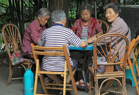Chengdu, China - June 15, 2015: chinese people are playing domino outdoor in park of Chengdu, Russiaのeditorial素材