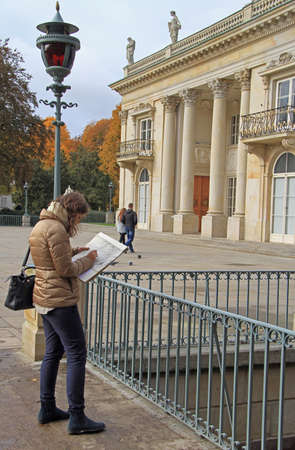 Warsaw, Poland - October 23, 2015: young woman is drawing building of Lazienki Palace in Warsaw, Polandのeditorial素材