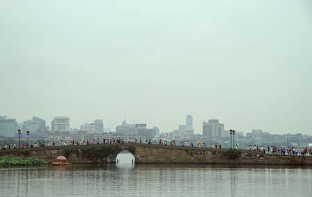Hangzhou, China - June 28, 2016: people are crossing the west lake in Hangzhou by bridge, Chinaのeditorial素材