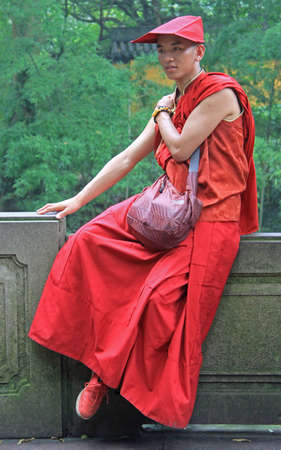 Hangzhou, China - June 29, 2016: buddhist monk in traditional clothes is resting outdoor in park of Hangzhou, Chinaのeditorial素材
