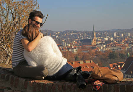 Graz, Austria - November 13, 2015: guy is hugging his girlfriend against the background of historical center of Graz, Austriaのeditorial素材