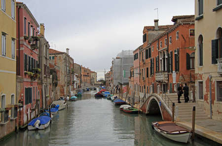 Venice, Italy - November 23, 2015: people are walking nearly the narrow water canal in Venice, Italyのeditorial素材
