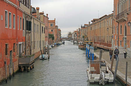Venice, Italy - November 23, 2015: people are walking nearly the narrow water canal in Venice, Italyのeditorial素材