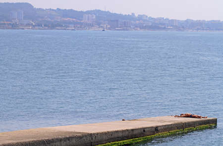 Sochi, Russia August 26, 2016: man is suthing on a pier in Khosta, Russiaの写真素材