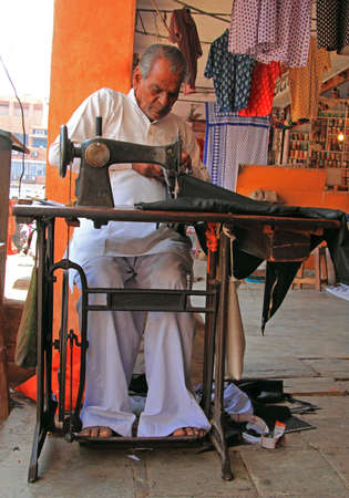 Jaipur, India - February 23, 2015: man is working with sewing machine in Jaipur, India