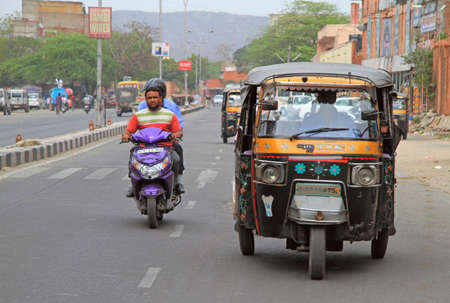 Jaipur, India - February 24, 2015: people are riding in vehicles by street in Jaipur, Indiaのeditorial素材