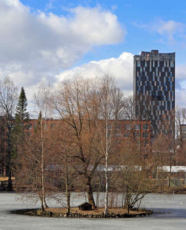 frozen pond and tall building in Tampereの写真素材