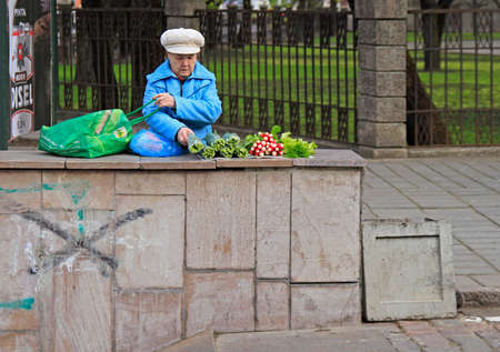 Kaunas, Lithuania - April 26, 2017: woman is selling vegetables outdoor in Kaunas, Lithuaniaのeditorial素材