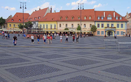 people are walking by the central square in Sibiu, Romaniaのeditorial素材