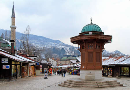 Sarajevo, Bosnia and Herzegovina - December 19, 2017: people are walking by Bascarsija square with Sebilj wooden fountain in Old Town Sarajevo, capital city of Bosnia and Herzegovinaのeditorial素材