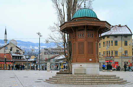 Sarajevo, Bosnia and Herzegovina - December 19, 2017: people are walking by Bascarsija square with Sebilj wooden fountain in Old Town Sarajevo, capital city of Bosnia and Herzegovinaのeditorial素材