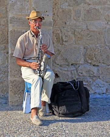 Paphos, Cyprus - November 24, 2017: musician is playing saxophone outdoor in Paphos, Cyprusのeditorial素材