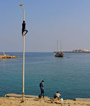 Kyrenia, Cyprus - November 18, 2017: adolescent are climbing pole outdoor in Kyrenia, Cyprusのeditorial素材