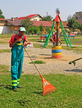 Brasov, Romania - July 25, 2017: street cleaner is doing his work outdoor in Brasov, Romania