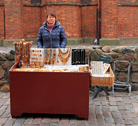 woman is selling souvenirs outdoor in Riga, Latviaのeditorial素材