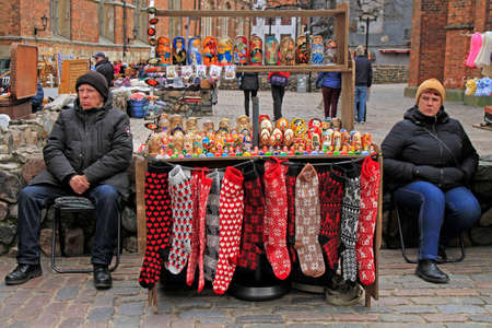 man and woman are selling souvenirs and warm clothes outdoorのeditorial素材