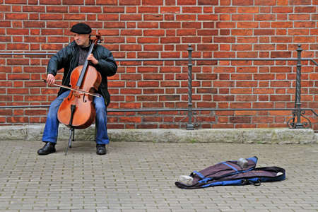 street musician is playing cello outdoor in Riga, Latviaのeditorial素材