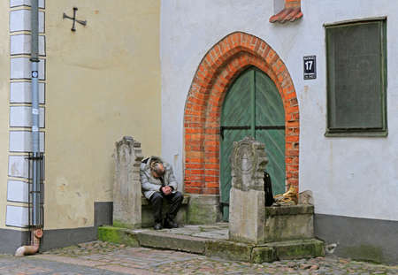 Riga, Latvia - April 29, 2017: alone musician took a moment for rest outdoor in Riga, Latviaのeditorial素材