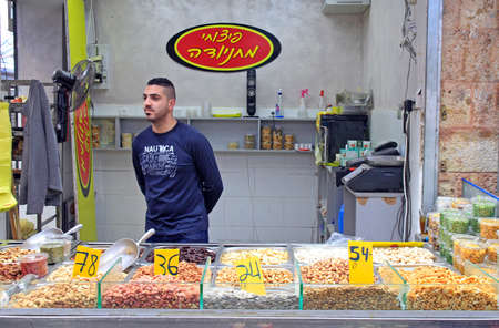 Jerusalem, Israel - December 1, 2017: man is selling dried fruits and nuts at Machane Yehuda Market in Jerusalem, Israelのeditorial素材