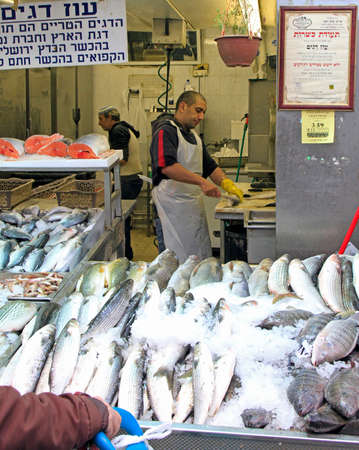 Jerusalem, Israel - December 1, 2017: man is fish at Machane Yehuda Market in Jerusalem, Israelのeditorial素材
