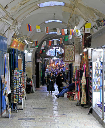 Jerusalem, Israel - December 3, 2017: tourists are walking by market in the old city of Jerusalem,...