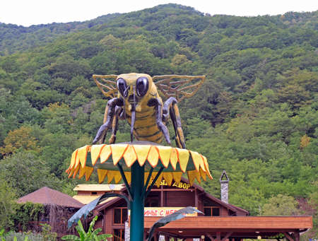 Sukhumi, Georgia - August 21, 2017: A huge sculpture of a bee on a flower near the halls degustation of honey in the apiary in the mountainsのeditorial素材