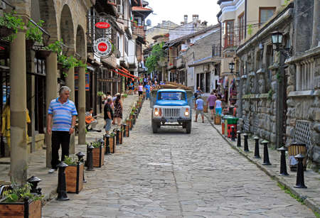 people are walking by the narrow street in Veliko Tarnovo