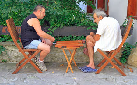 men are playing backgammon outdoors in Veliko Tarnovo, Bulgariaのeditorial素材