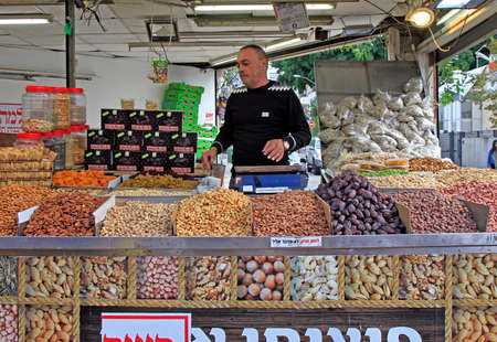 Tel Aviv, Israel - November 30, 2017: man sells nuts and dry dfuits at Carmel market in Tel-Aviv, Israelのeditorial素材