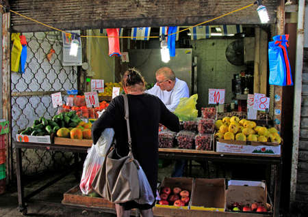 Tel Aviv, Israel - November 30, 2017: man sells fruits at Carmel market in Tel Aviv, Israelのeditorial素材