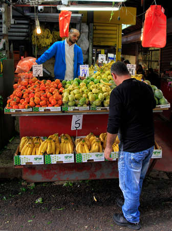 Tel Aviv, Israel - November 30, 2017: man sells fruits outdoors at Carmel market in Tel Aviv, Israelのeditorial素材