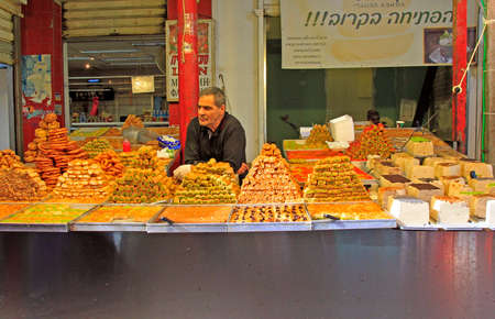 Tel Aviv, Israel - November 30, 2017: man sells oriental sweets at Carmel market in Tel-Aviv, Israelのeditorial素材