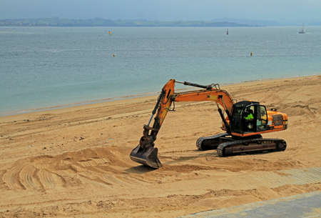 excavator working on the beach in Santanderの写真素材