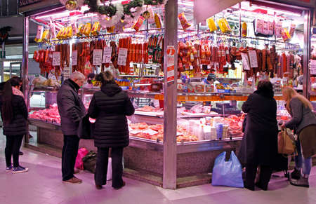 Turin, Italy - December 19, 2019: stall with meat and sausages on city market in Turinのeditorial素材