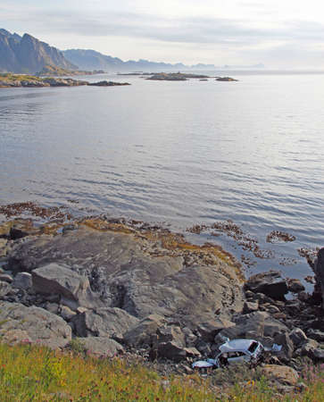 fallen car at shore on Lofoten islandsの写真素材