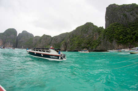 KRABI, THAILAND - April 28, 2017: Holidaymakers relaxing on the beach in Railay Beach. This is a popular tourist destination. Image contain certain grain or noise and soft focus.のeditorial素材