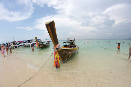 KRABI, THAILAND - April 28, 2017: Holidaymakers relaxing on the beach in Railay Beach. This is a popular tourist destination. Image contain certain grain or noise and soft focus.のeditorial素材