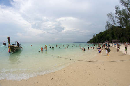 KRABI, THAILAND - April 28, 2017: Holidaymakers relaxing on the beach in Railay Beach. This is a popular tourist destination. Image contain certain grain or noise and soft focus.のeditorial素材