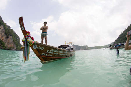 KRABI, THAILAND - April 28, 2017: Holidaymakers relaxing on the beach in Railay Beach. This is a popular tourist destination. Image contain certain grain or noise and soft focus.のeditorial素材